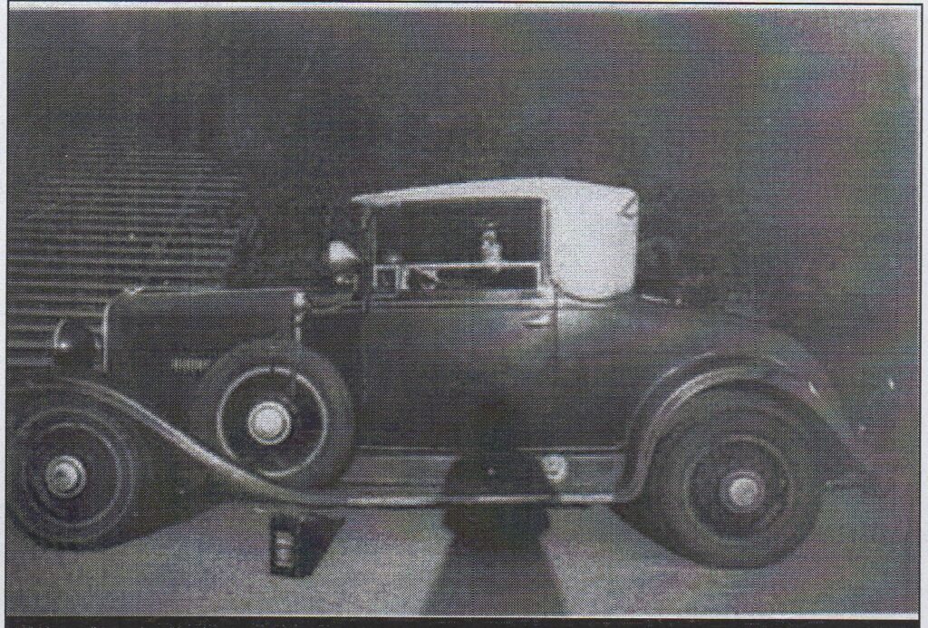 Oppenheimer takes photo of Melba in his car.