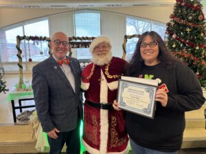 Dr. Dempsey and Santa award Nicole Employee of the Month.