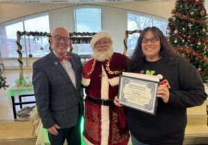 Dr. Dempsey and Santa award Nicole Employee of the Month.